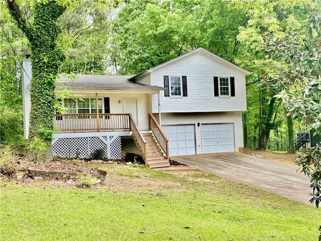 tri-level home with a porch, a front yard, stairway, concrete driveway, and an attached garage