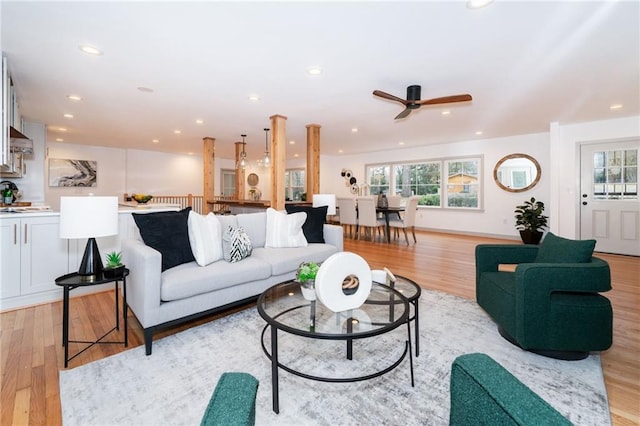 living room featuring ceiling fan, light hardwood / wood-style flooring, and a healthy amount of sunlight