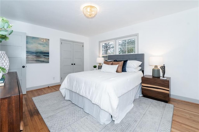 bedroom with a closet and light hardwood / wood-style flooring