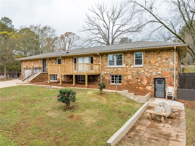 rear view of house featuring a yard and a wooden deck