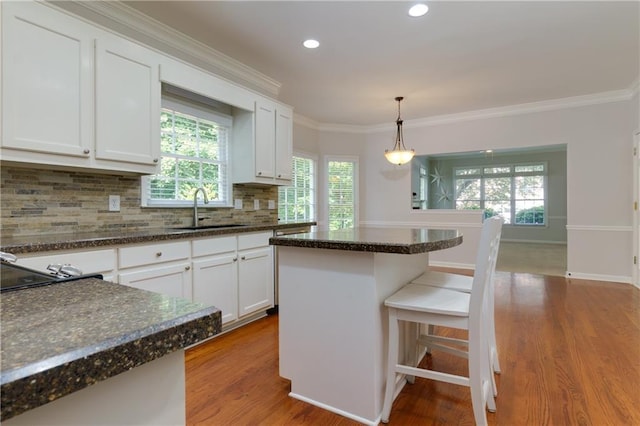 2995 Aspen Ridge Ct, Snellville, GA 30078 - kitchen with a sink, wood finished floors, backsplash, white cabinets, and crown molding