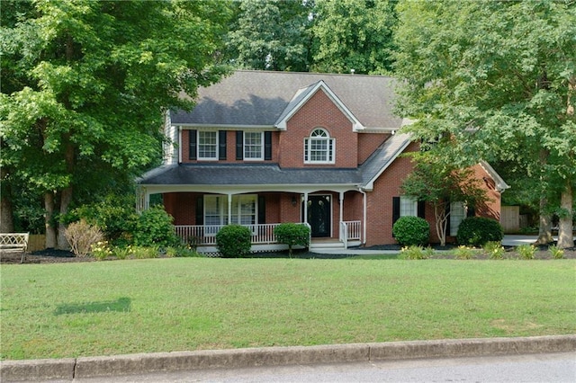 2995 Aspen Ridge Ct, Snellville, GA 30078 - view of front of house with covered porch, a front lawn, and brick siding