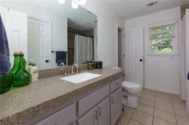 2995 Aspen Ridge Ct, Snellville, GA 30078 - bathroom with vanity, tile patterned floors, toilet, baseboards, and a textured ceiling