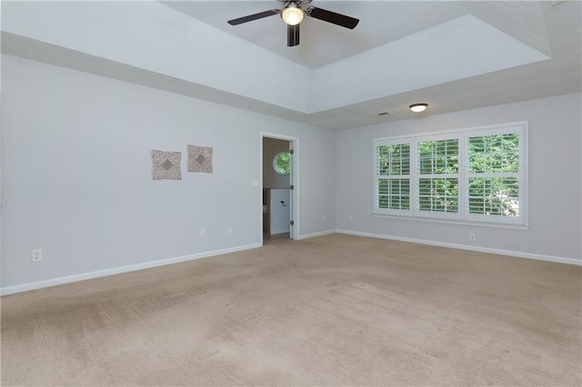2995 Aspen Ridge Ct, Snellville, GA 30078 - spare room featuring light carpet, ceiling fan, baseboards, and a raised ceiling
