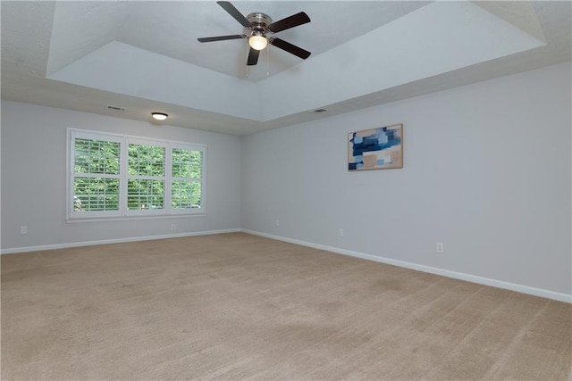 2995 Aspen Ridge Ct, Snellville, GA 30078 - empty room featuring a tray ceiling, ceiling fan, and baseboards