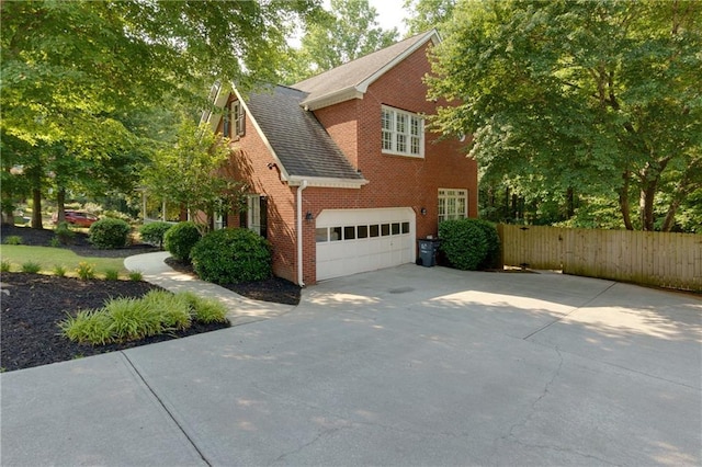 2995 Aspen Ridge Ct, Snellville, GA 30078 - view of home's exterior with driveway, brick siding, a garage, and roof with shingles