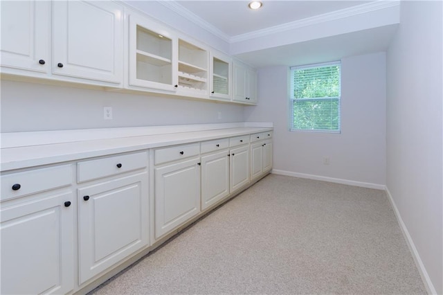 2995 Aspen Ridge Ct, Snellville, GA 30078 - kitchen with baseboards, glass insert cabinets, white cabinets, light countertops, and crown molding