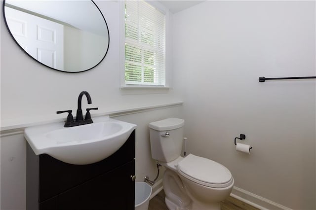 2995 Aspen Ridge Ct, Snellville, GA 30078 - bathroom with vanity, toilet, baseboards, and wood finished floors