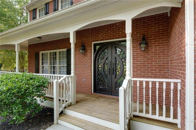 2995 Aspen Ridge Ct, Snellville, GA 30078 - doorway to property with a porch and brick siding
