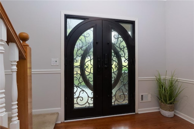 2995 Aspen Ridge Ct, Snellville, GA 30078 - entryway with french doors, wood finished floors, stairs, and baseboards