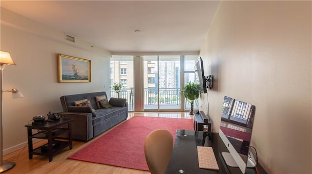3338 Peachtree Rd NE Unit 1506, Atlanta, GA 30326 - living room featuring wood finished floors, floor to ceiling windows, and baseboards