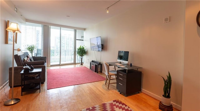 3338 Peachtree Rd NE Unit 1506, Atlanta, GA 30326 - home office with wood finished floors, track lighting, expansive windows, and baseboards