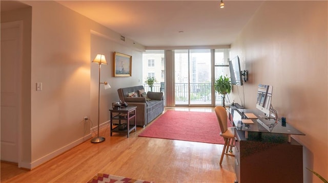 3338 Peachtree Rd NE Unit 1506, Atlanta, GA 30326 - living area with light wood finished floors, floor to ceiling windows, and baseboards