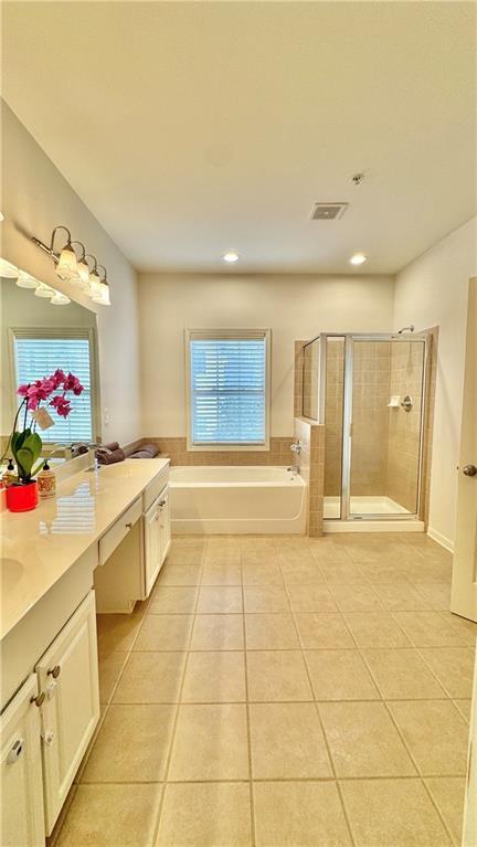 bathroom with a garden tub, visible vents, a stall shower, vanity, and tile patterned flooring