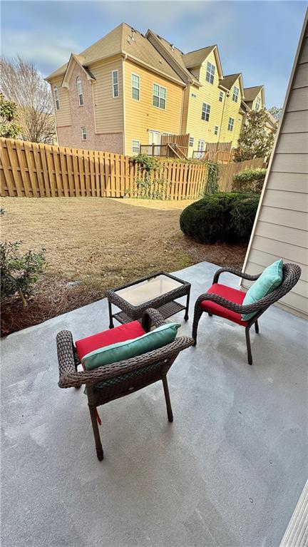 view of patio / terrace featuring a residential view and fence