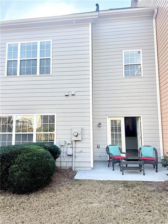 back of house with a patio and a yard