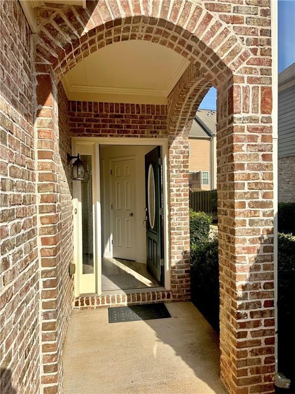 doorway to property with brick siding