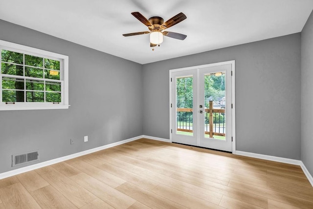 4260 Bonaparte Dr, Tucker, GA 30084 - unfurnished room featuring plenty of natural light, ceiling fan, light wood-style floors, and french doors