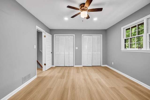 4260 Bonaparte Dr, Tucker, GA 30084 - unfurnished bedroom featuring multiple closets, light wood-type flooring, recessed lighting, and a ceiling fan