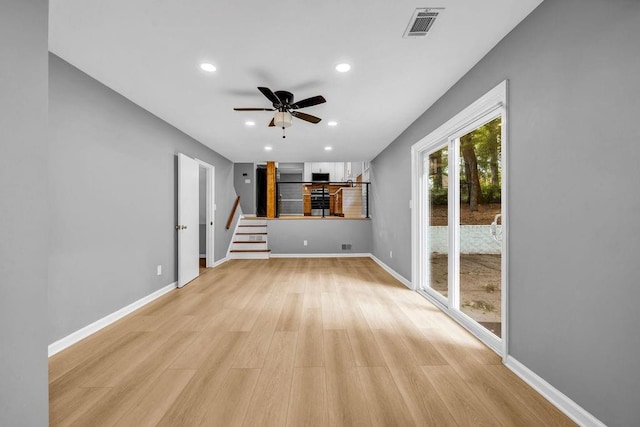 4260 Bonaparte Dr, Tucker, GA 30084 - unfurnished living room with recessed lighting, light wood-style floors, a ceiling fan, and stairway