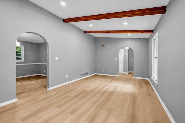 4260 Bonaparte Dr, Tucker, GA 30084 - empty room with arched walkways, light wood-type flooring, recessed lighting, and beam ceiling