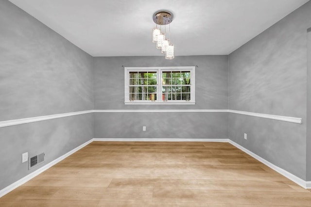 4260 Bonaparte Dr, Tucker, GA 30084 - spare room with wood finished floors and a chandelier