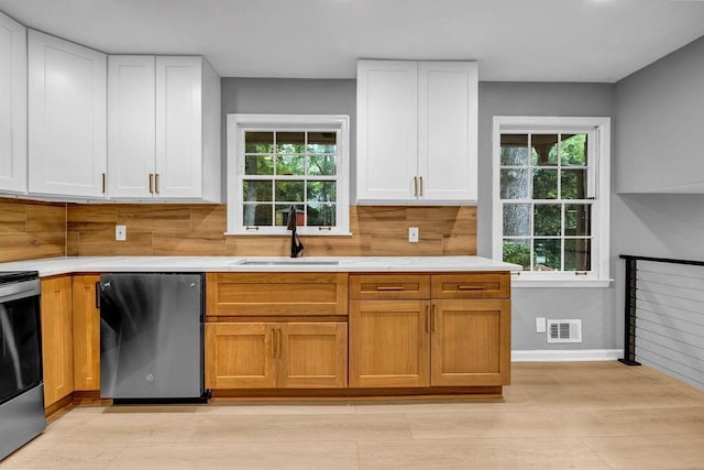 4260 Bonaparte Dr, Tucker, GA 30084 - kitchen featuring dishwasher, healthy amount of natural light, stainless steel range with electric cooktop, and white cabinetry