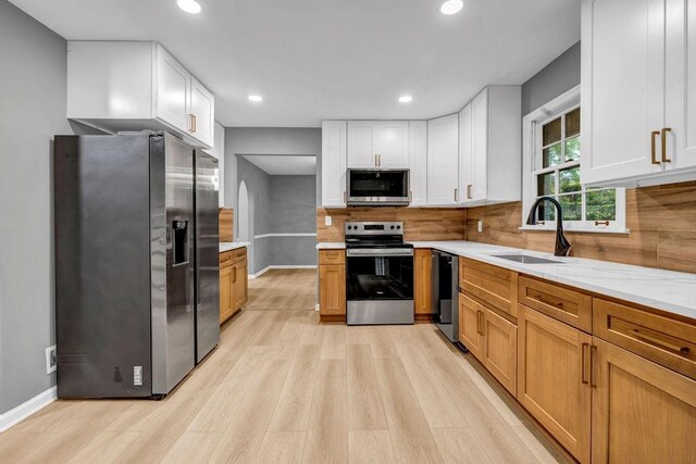 4260 Bonaparte Dr, Tucker, GA 30084 - kitchen featuring appliances with stainless steel finishes, light wood-style floors, recessed lighting, decorative backsplash, and white cabinetry