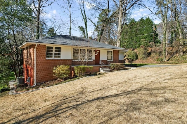 single story home with central AC unit and a porch