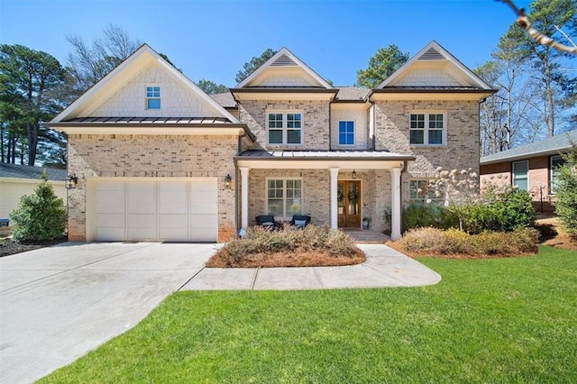 craftsman-style home with a garage, concrete driveway, a standing seam roof, a front yard, and brick siding