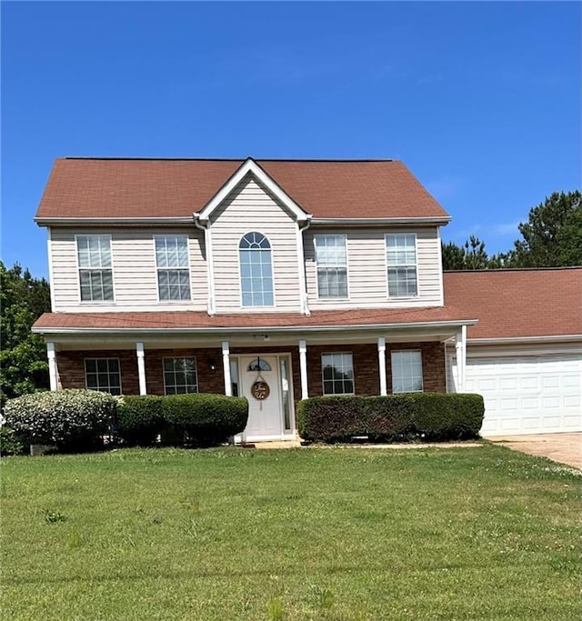 5458 Stagecoach Rd, Ellenwood, GA 30294 - colonial home featuring an attached garage, a front yard, driveway, and a porch