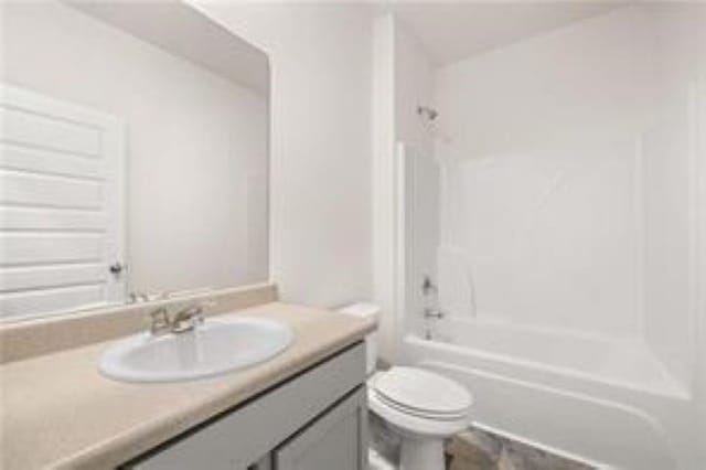 bathroom featuring vanity, shower / bathing tub combination, and toilet