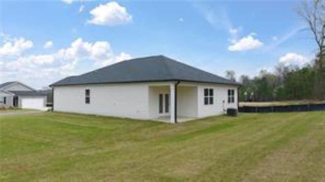 view of side of home with a lawn