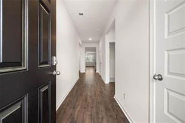 hall with baseboards, recessed lighting, and dark wood-style floors