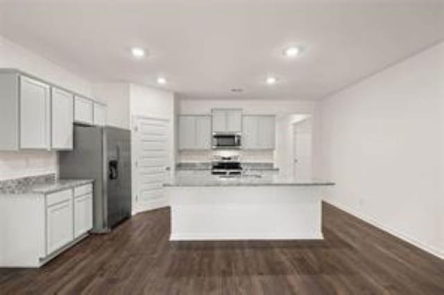 kitchen featuring decorative backsplash, appliances with stainless steel finishes, light countertops, dark wood-style floors, and recessed lighting