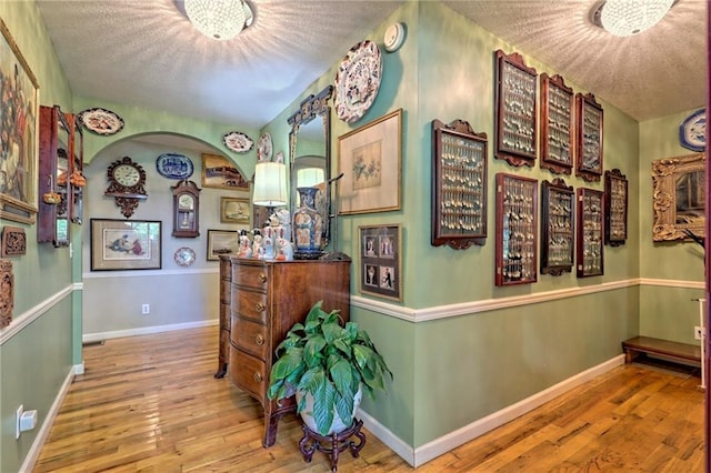 476 Franklin St, Dillard, GA 30537 - hall with a textured ceiling, hardwood / wood-style floors, and arched walkways