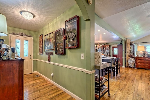 476 Franklin St, Dillard, GA 30537 - corridor with a textured ceiling, wood finished floors, and a chandelier