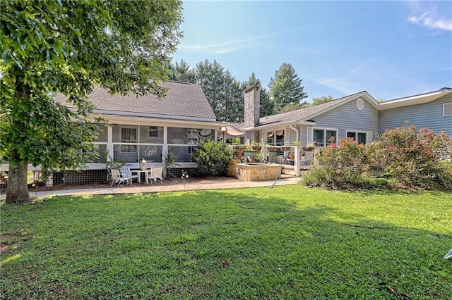 476 Franklin St, Dillard, GA 30537 - rear view of house with a patio, a chimney, a lawn, and a sunroom