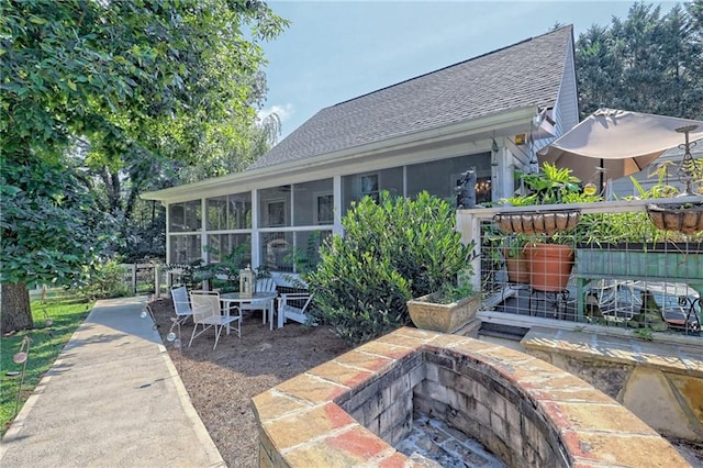 476 Franklin St, Dillard, GA 30537 - rear view of property with roof with shingles, a sunroom, a fire pit, and a patio area