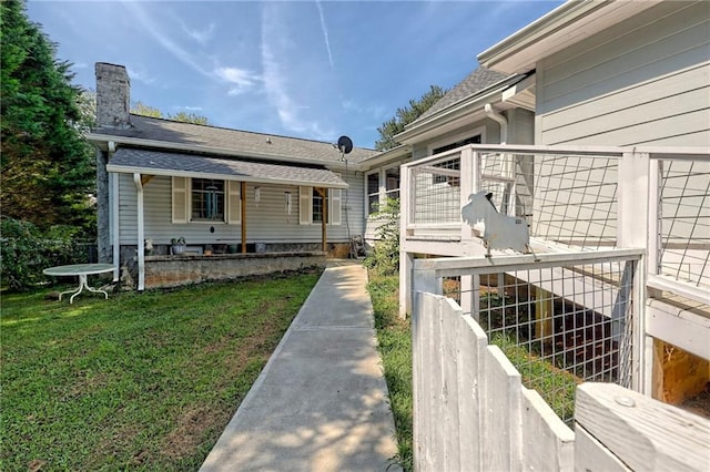 476 Franklin St, Dillard, GA 30537 - rear view of property featuring a chimney, a lawn, and a shingled roof