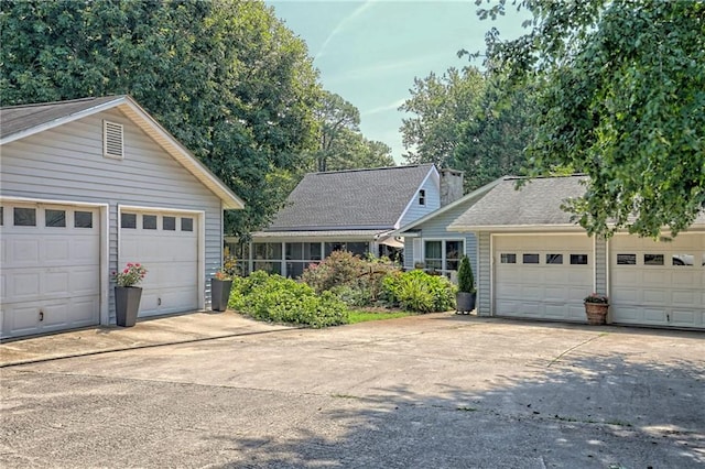 476 Franklin St, Dillard, GA 30537 - view of front of house featuring a detached garage, a chimney, and an outbuilding