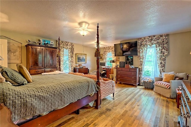476 Franklin St, Dillard, GA 30537 - bedroom with light wood-style flooring, a textured ceiling, and ceiling fan