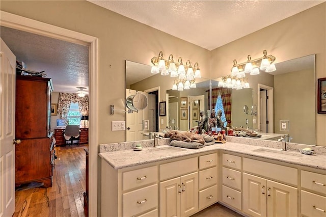 476 Franklin St, Dillard, GA 30537 - ensuite bathroom with hardwood / wood-style flooring, double vanity, and a textured ceiling