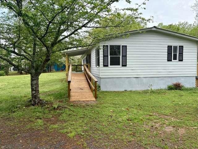 view of property exterior with a lawn