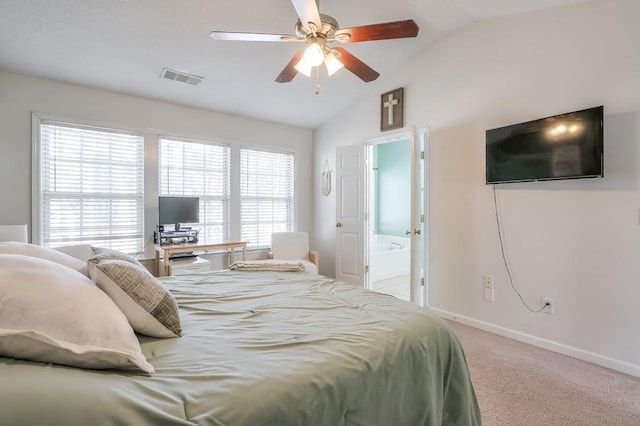 bedroom featuring lofted ceiling, ensuite bath, ceiling fan, and carpet