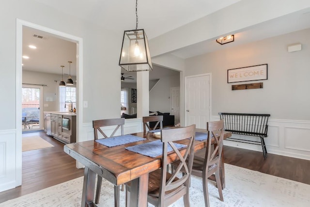 dining space with dark wood-type flooring and sink