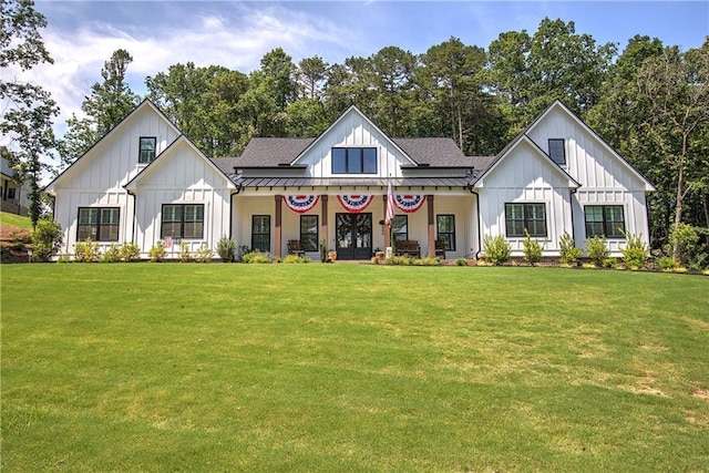 884 Oxford Rd, Ball Ground, GA 30107 - modern inspired farmhouse with a standing seam roof, board and batten siding, a front yard, and a metal roof