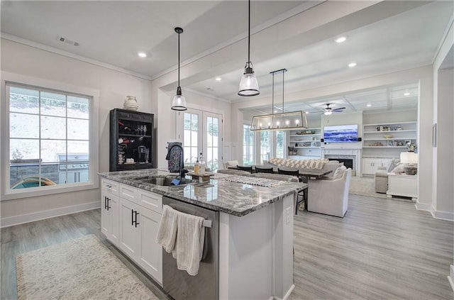 884 Oxford Rd, Ball Ground, GA 30107 - kitchen with stainless steel dishwasher, crown molding, light stone countertops, plenty of natural light, and a center island with sink
