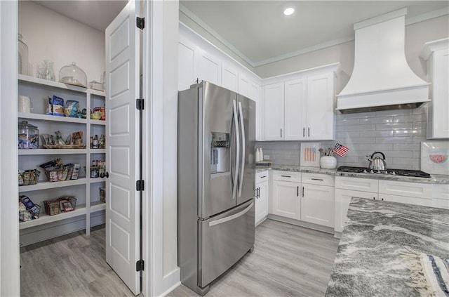 884 Oxford Rd, Ball Ground, GA 30107 - kitchen with appliances with stainless steel finishes, custom exhaust hood, light wood-style flooring, white cabinetry, and recessed lighting