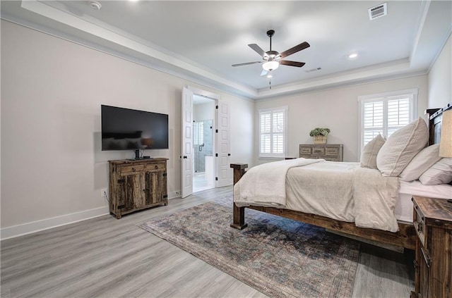 884 Oxford Rd, Ball Ground, GA 30107 - bedroom featuring a tray ceiling, multiple windows, light wood finished floors, crown molding, and recessed lighting